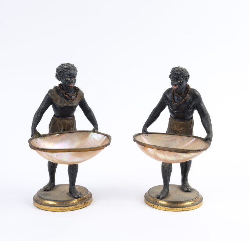 A pair of Blackamoor figural bonbon dishes, cold painted spelter with pearl shell, 19th century, ​24cm high