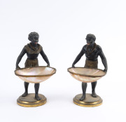 A pair of Blackamoor figural bonbon dishes, cold painted spelter with pearl shell, 19th century, ​24cm high