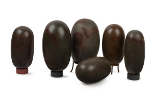 SHIVA LINGAM: Six antique polished stones from the Narmada River, India, the largest 19cm high
