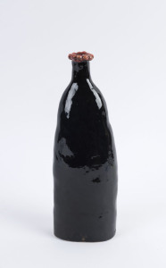 ARTIST UNKNOWN Hand-built pottery bottle, black glaze with red rim, mid 20th century, 28cm high
