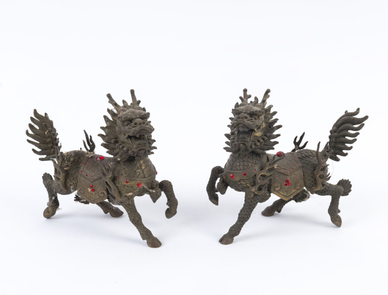 A pair of Chinese bronze lion statues with red diamante decoration, mid 20th century, ​15cm high