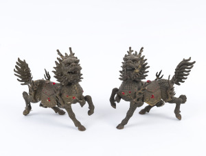 A pair of Chinese bronze lion statues with red diamante decoration, mid 20th century, 15cm high
