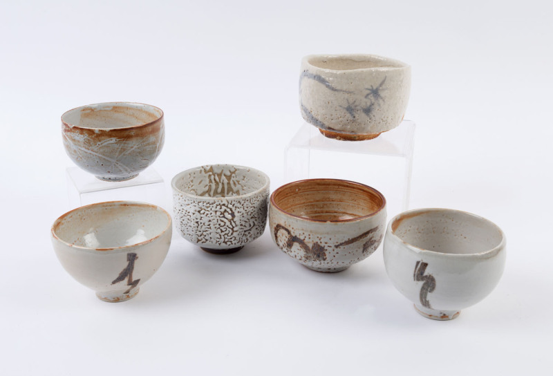 Six Australian studio pottery bowls with cream glazes, ​the largest 9cm high, 13cm wide
