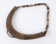 A tribal necklace, carved wood with synthetic rope, Papua New Guinea, mid 20th century, ​pendant 31cm wide