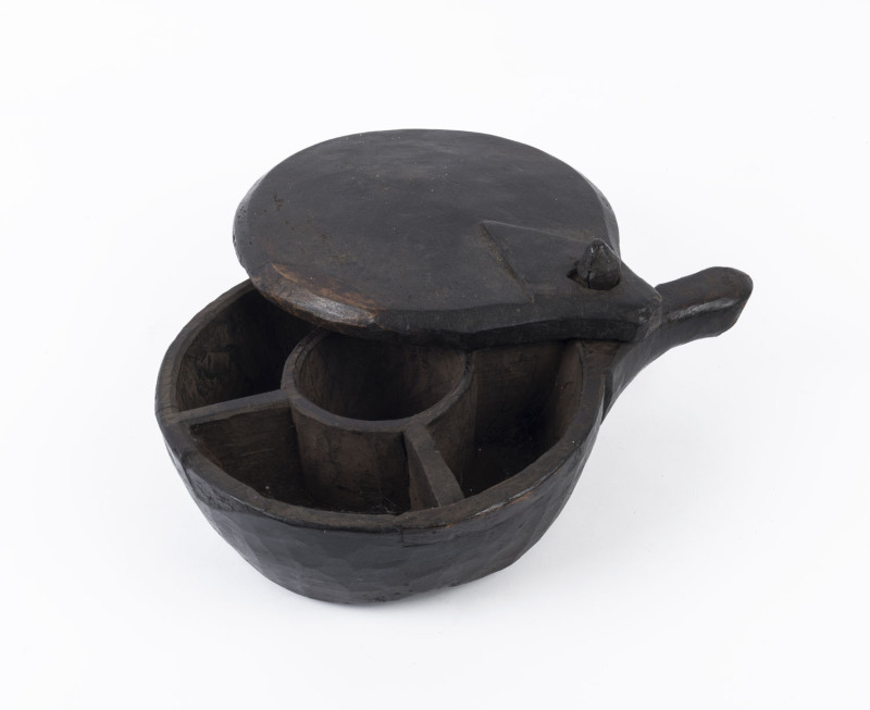 A tribal box, carved timber with swivel top lid, 19th/20th century, 13cm high, 36cm wide