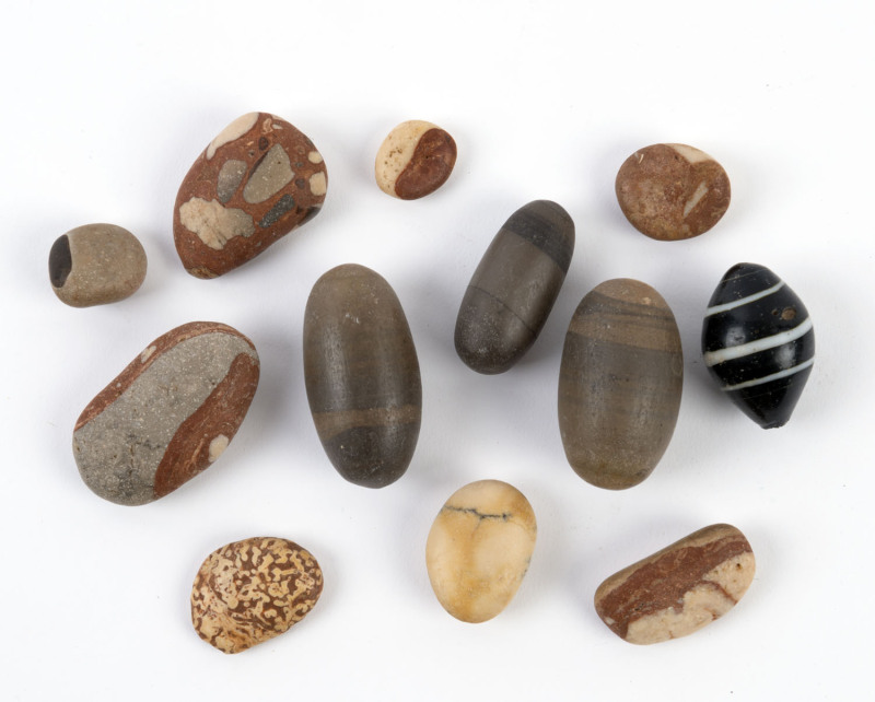 Antique Tibetan glass bead, three Shiva Lingam stones and eight Narmada River pebbles, (12 items), ​Tibetan bead 3.5cm long