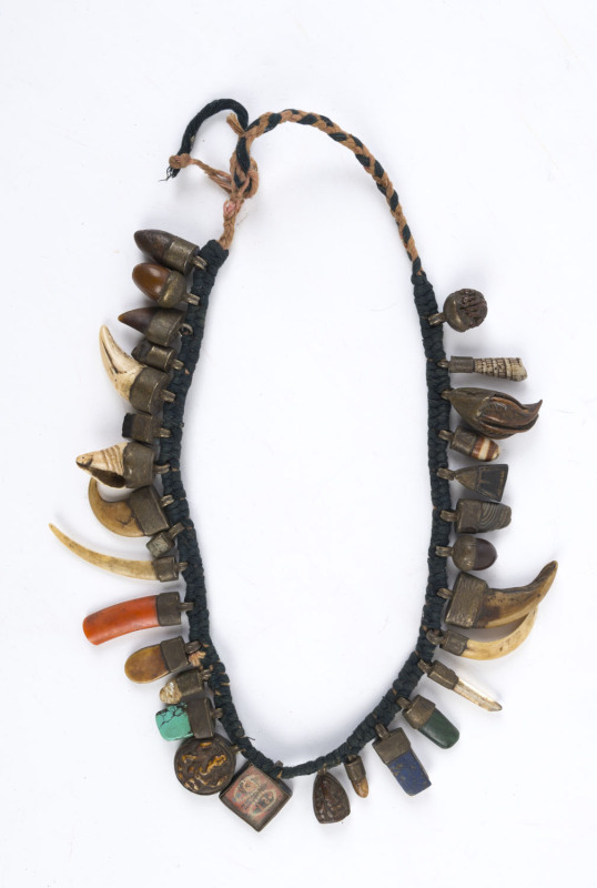 Tibetan charm necklace adorned with assorted shells, claws, stones and charms, ​52cm long