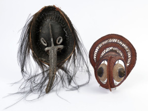 Two tribal masks, wood, woven fibre and feather with painted finish, Papua New Guinea, the larger 50cm high