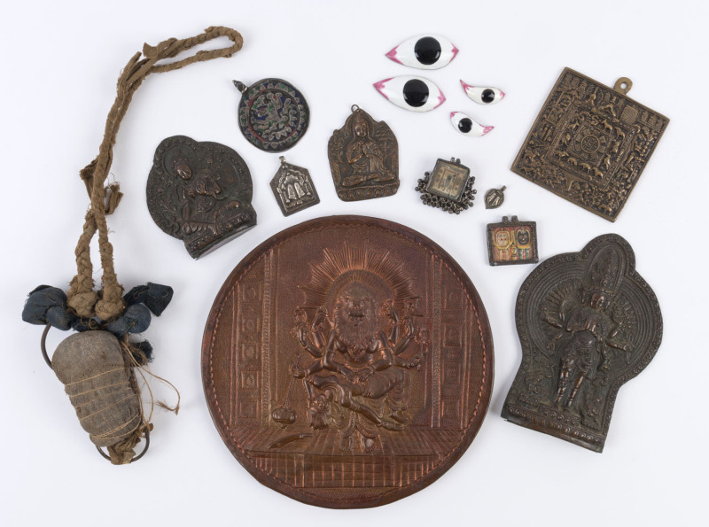 Group of assorted Indian artefacts including pendants, enamel eyes, copper plaque, Hindu statues etc, 19th and 20th century, large circular plaque 23cm diameter