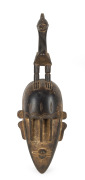 A ceremonial mask with bird totem, carved hardwood, West African origin, ​50cm high