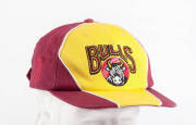 ANDY BICHEL'S QUEENSLAND CRICKET CAP, from 1998-99 season, baseball-style, maroon & yellow with Bulls logo embroidered on front, signed inside by Andy Bichel. G/VG condition. [Andy Bichel played 19 tests & 67 ODIs 1997-2004].