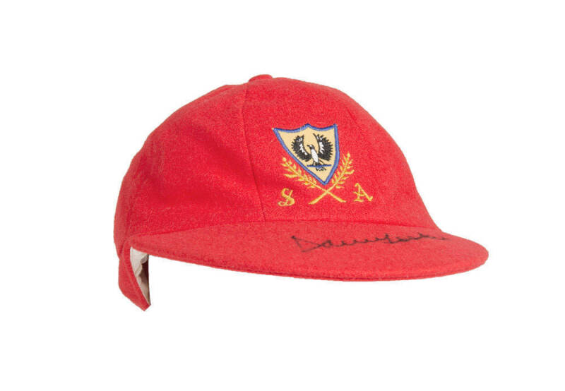 DAVID HOOKES' SOUTH AUSTRALIA CRICKET CAP, red with SA logo embroidered on front, signed on brim by David Hookes. Good match-used condition. [David Hookes played 23 Tests & 39 ODIs 1977-86].