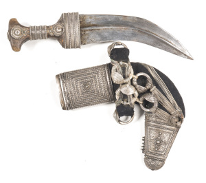 SAUDI-ARABIAN SILVER MOUNTED JAMBIA: 7½” curved blade of traditional form with central raised rib & light staining; horn hilt mounted in filigreed silver; the locket & chape of the scabbard are typically made of filigreed silver; central of the scabbard a