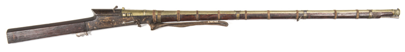 INDIAN MATCHLOCK LONG GUN: 680 Cal; 43" brass barrel enhanced with an intricate pattern & secured by 4 brass bands & 9 interwoven twine bands; bell mouthed muzzle with foliage in relief; g. breech with pan cover & vent pricker & chain; vg profiles with cl