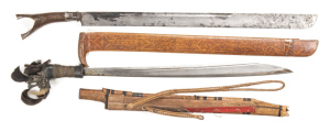 LOT X 2: BORNEO HEAD HUNTER'S SWORD: vg 20½" blade with groove to back edge on rhs; ebony grip bound with intricate woven brass wire; dragon's head pommel with hair decoration; complete with vg curved wooden scabbard. KLEWANG KNIFE SWORD: broad 23" blade 