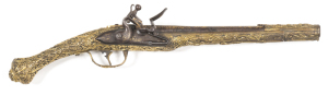 TURKISH FULL STOCKED ALL METAL FLINTLOCK HOLSTER PISTOL: 18 bore; 11" barrel; p. bore; curved lock plate fitted with a swan necked cock & integral pan; gilt brass full stock featuring trophies & flags, birds of prey, foliage, rosettes, dragons & grotesque