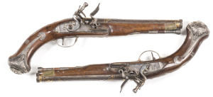 PR OF TURKISH FULL STOCKED FLINTLOCK SILVER MOUNTED HOLSTER PISTOLS: Made in the English style; 25 bores; 8¼" damascus barrels with decorative gold inlays to the cannon shaped muzzles & breeches; stepped lock plates with Farsi inscriptions; fitted with sw