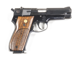 SMITH & WESSON MODEL 39-2 S/A PISTOL: 9mm; 8 shot mag; 102mm (4") barrel; g. bore; std sights; S&W plus address to lhs of slide; Trade mark to rhs of frame; sharp profiles, clear makings; 85% orig blue finish remains to slide & alloy frame; g. S&W wooden 