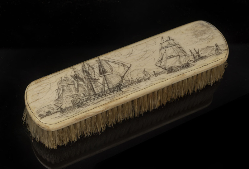 A scrimshaw whalebone brush with naval scene, 19th century, 16.5cm across