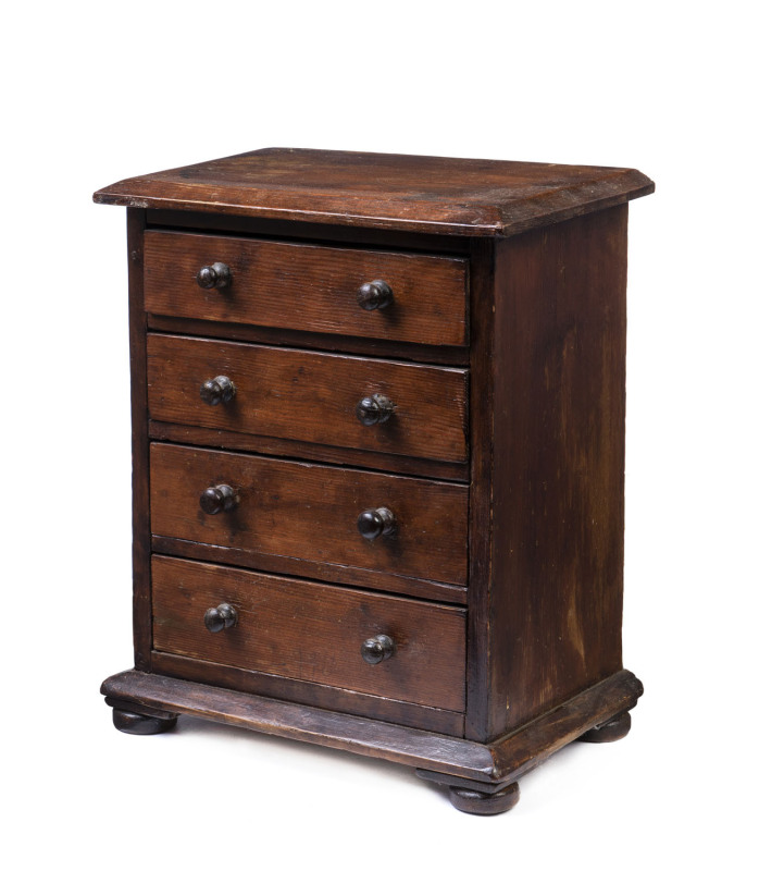 An Australian apprentice chest, stained red pine, circa 1900, top to drawers fitted with compartments, 35.5cm high, 29cm wide, 19cm deep. PROVENANCE: The Rodney Pemberton Collection