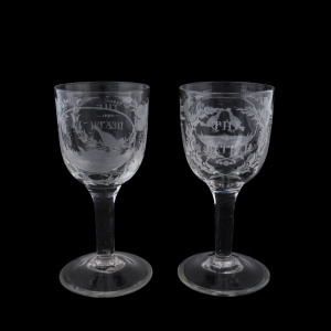 A fine pair of English wine glasses engraved with cock fighting scenes titled "THE BATTLE" and "THE DEATH", late 18th early 19th century, 17.5cm high