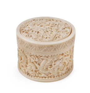 A Chinese circular jewellery box, carved ivory with dragon motif, circa 1900, 6cm high, 8cm diameter