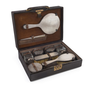 An English sterling silver travel set in fine leather case, London, circa 1915, the case 34cm across