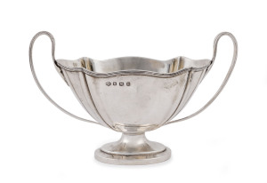 An English sterling silver bowl with two handles, made in Sheffield, circa 1925, 12cm high, 19cm across the handles, 230 grams