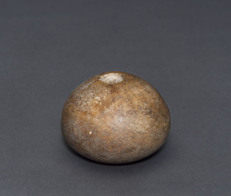 An Egyptian limestone mace head, predynastic Gerzeh culture, Naqada II, circa 3300 B.C. 4cm high, 5.5cm wide. PROVENANCE: The Josef Mueller Collection, Christie's London, 1979.