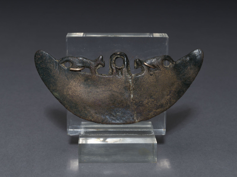 An Egyptian bronze axe head of slender crescent form decorated with lion figures, circa 600-700 B.C. Old repair near centre. 10.5cm wide. PROVENANCE: Christie's New York, 18th, October 1982, formerly The Museum Of Archaeology Staten Island New York.