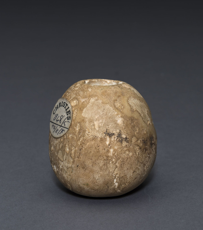 An Egyptian limestone mace head, Naqada II, circa 3000 B.C. 5.5cm high, 5cm wide. PROVENANCE: Christie's London, 1979, The Joseph Mueller Collection