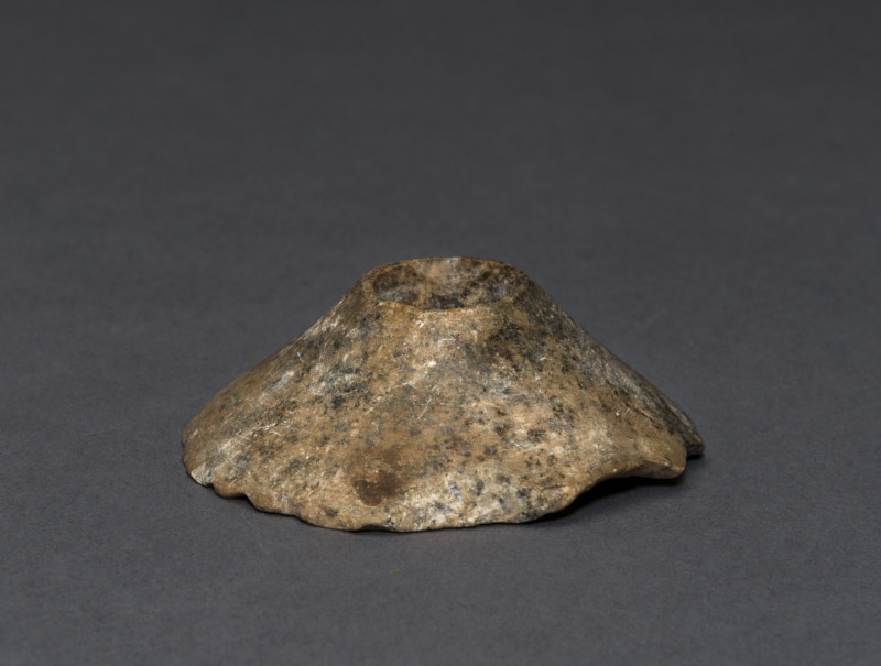 An Egyptian granite stone mace head, Naqada I, circa 3500 B.C. 2cm high, 5.5cm wide. PROVENANCE: The Josef Mueller Collection, Christie's London, November, 1979.