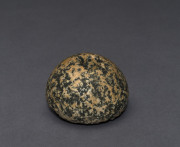 An Egyptian speckled granite stone mace head, Naqada II, circa 2300 to 3100 B.C. 4cm high, 6cm wide. PROVENANCE: Christie's London, Nov. 1979, a private Swiss Collection.