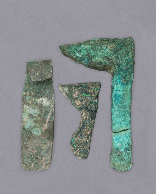 Three SUMER bronze axe heads, southern Mesopotamia, 3000 B.C. 18cm, 15cm and 10cm long. PROVENANCE: The Charles Eade Collection