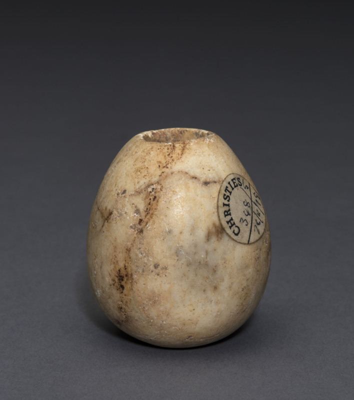 An Egyptian limestone mace head, Naqada II, circa 3000 B.C. 6cm high, 5cm wide. PROVENANCE: Christie's London, 1979, The Joseph Mueller Collection