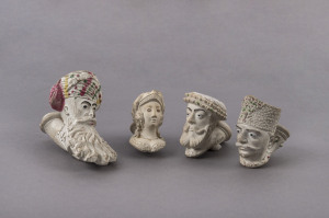 Four assorted French portrait clay pipes, two in the form of an Ottomans heads, 19th century, the largest 8.5cm long