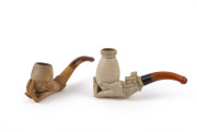 Two antique pipes, carved meerschaum in the of hands with amber mouth pieces, both in fitted cases, 19th century, 9.5cm and 10cm long - 2