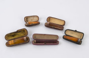Five assorted cigar holders, amber with gold and silver mounts, all in plush fitted cases, 19th century, ​the largest 7.5cm long