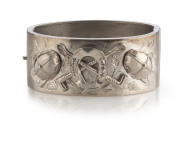 An antique English sterling silver bangle with jockey motif, 19th century, ​6cm wide, 35 grams