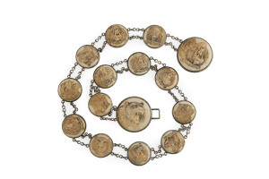 A Japanese belt set with fifteen carved ivory animal head roundels, Meiji period, late 19th century, 80cm long
