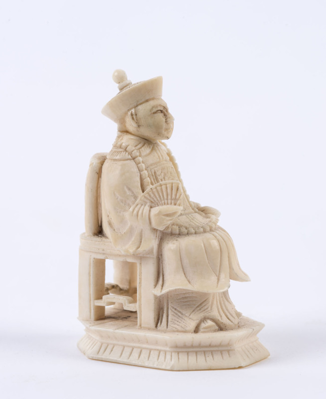 A Chinese carved ivory statue of a seated official, late 19th early 20th century, ​6cm high