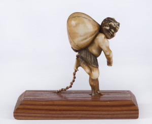 A Japanese carved ivory netsuke, Meiji period, on later wooden base for display purposes, 6cm high