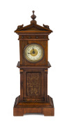 A walnut cased mantel clock in the form of a grandfather clock, most likely German, late 19th century, ​31cm high