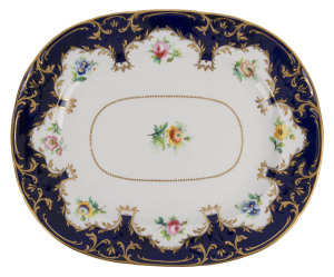 An English porcelain platter with hand-painted enamel floral vignettes, blue border with gilt highlights, circa 1840, 32cm wide