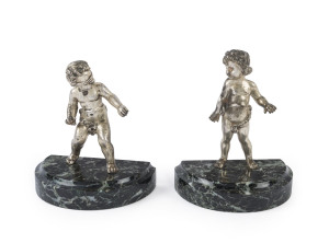A pair of "Putti" bookends, silvered bronze on vert marble plinths, 19th century, 14cm high