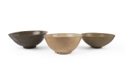 Three Thai ceramic bowls, celadon and brown glazed, 15th/16th century, ​the largest 7cm high, 18cm diameter