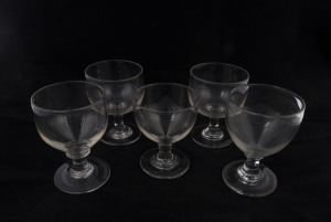 Five assorted antique English wine glasses, early 19th century, ​the largest