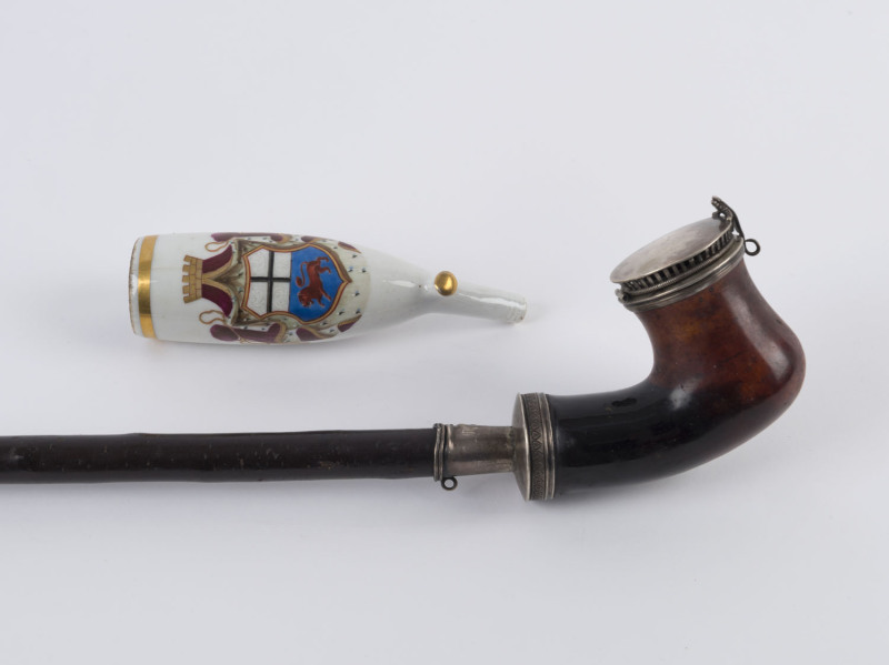 An antique hand-painted porcelain pipe bowl and a German long pipe with silver mounts (no mouthpiece), 19th century, (2 items), the German pipe 69cm long