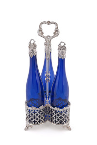 A Georgian Sheffield plate three bottle decanter stand, Bristol blue decanters with silver mounted tops, early 19th century, 46cm high