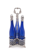 A Georgian Sheffield plate three bottle decanter stand, Bristol blue decanters with silver mounted tops, early 19th century, 46cm high